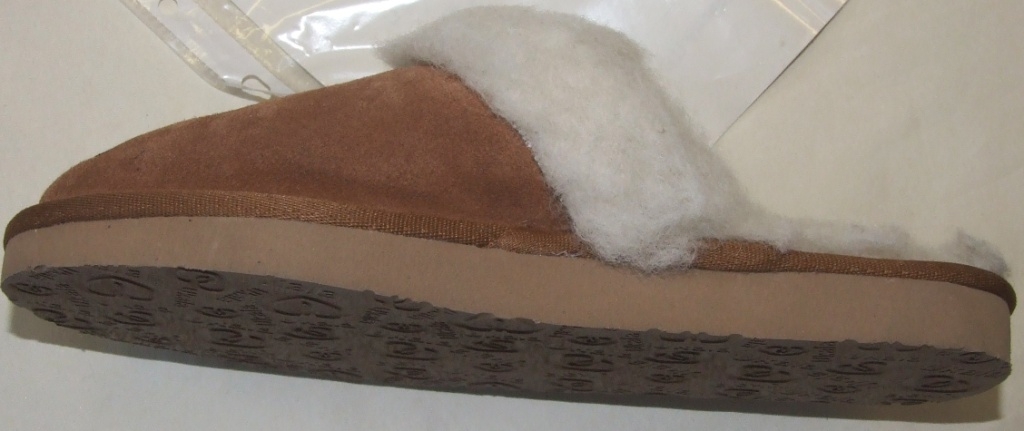 MULE STYLE SLIIPER WITH  UPPERS OF LEATHER (SUEDE) AND OUTER SOLES OF EVA WITH COMPANY NAME AND LOGO IMPRINTED INTO THE EVA. WITH A KNITTED PILE WOOL LINING. A LABEL SHOWING THE COMPANY NAME IS SEWN ONTO THE TOP OF THE SLIPPER. IN-SOLE LENGTH EXCEEDS 24 CMS. CONSIGNED FROM CHINA. SAMPLE SEEN IS LIGHT BROWN.