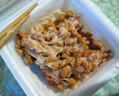INGREDIENTS: SOY BEANS, BACILLUS SUBTILIS. THE OTHER INGREDIENTS ARE SAUCES WHICH CAN BE USED TO MIX WITH THE NATTO. SAUCE SACHET (NET WEIGHT 5.5G) CONSISTS OF: WATER, HIGH -FRUCTOSE CORN SYRUP, SALT, BONITO EXTRACT, SOY SAUCE, SUGAR, KELP EXTRACT, SEASONING (AMINO ACIDS), ACIDULANT AND THICKENER. ALSO COMES WITH A MUSTARD SACHET (0.8G): OF WATER, MUSTARD, SUGAR, VINEGAR, SALT, ALCOHOL. ACIDULANT, COLOURING (TURMERIC), THICKENER. FLAVOURING, SEASONING (AMINO ACIDS) AND SPICES. THE SOY BEANS ARE STEAMED FIRST, THEN PARTLY FERMENTED WITH THE BACILLUS SUBTILIS. THE NATTO CAN BE EATEN ON ITS OWN OR WITH RICE. IT IS FROZEN FOR STORAGE. PACKAGED FOR RETAIL CONSUMERS, THE INNER PACKAGING IS A POLYSTERENE BOX TO PROTECT THE PRODUCT, WITH A PLASTIC FILM LABEL ON IT. THE OUTER PACKAGING IS A REGULAR CARDBOARD BOX.