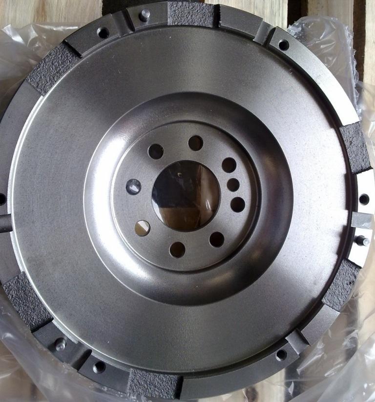 A FLYWHEEL TO BE USED IN AN INTERNAL COMBUSTION ENGINE. IT IS CONSTRUCTED FROM CAST IRON SO THAT THE WEIGHT IS CONCENTRATED NEAR THE RIM. . THE FLYWHEEL IS A HEAVY SHAFT-MOUNTED ROTATING DISC THAT ABSORBS AND STORES TWISTING OR SPINNING MOTION AND THEN RELEASES IT AS ROTATIONAL KINETIC ENERGY TO PROVIDE MOTION TO A STATIONARY OR NEARLY STATIONARY OBJECT.