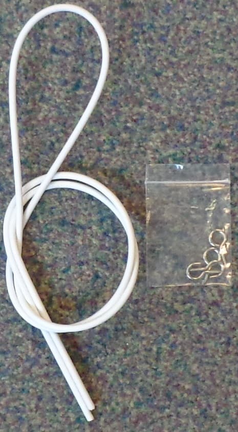 COILED STEEL WIRE COVERED IN WHITE PLASTIC, APPROX 3MM IN DIAMETER FOR USE TO HANG NET CURTAINS.
PACKAGED FOR RETAIL SALE WITH SMALL METAL HOOKS FOR HANGING IT.