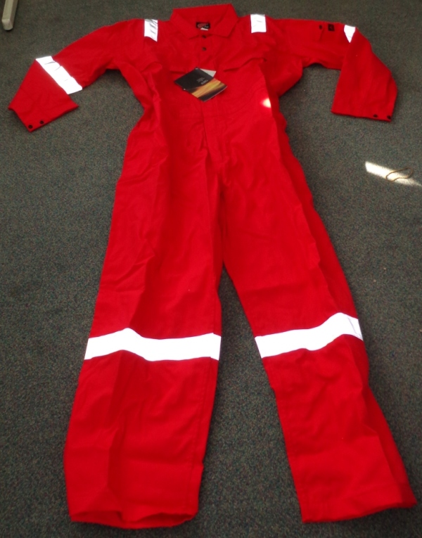 A WOVEN COVERALL OF 100% COTTON. IT IS A FLAME RESISTANT ARTICLE FOR USE IN WORKING ENVIRONMENTS WHERE EXPOSURE TO HIGH HEAT OR FLAMES MAY OCCUR.
IT HAS A CENTRAL ZIP FROM THE CHEST DOWN TO THE TOPS OF THE LEGS, COVERED WITH A LEFT OVER RIGHT FLAP AND WITH TWO PRESS STUDS ABOVE THE ZIP AT THE TOP. THERE ARE TWO BREAST POCKETS, EACH CLOSING WITH A ZIP, AND A SMALL POCKET ON THE LEFT ARM CLOSING WITH A PRESS STUD. THE REAR OF THE LOWER BACK HAS TWO POCKETS, EACH WITH A FLAP BUT NO CLOSING MECHANISM.
IT IS RED IN COLOUR WITH SILVER REFLECTING STRIPS ON THE LEGS, ARMS AND SHOULDERS. ENCLOSED IN A PLASTIC BAG.