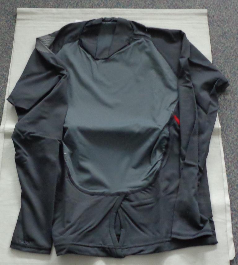 A LIGHTWEIGHT, FINE KNIT, TURTLE NECK PULLOVER FOR UNISEX. REACHING DOWN TO BELOW THE WAIST. CLOSE FITTING. ROUND NECK WITH COLLAR (MEASURING APPROXIMATELY 6.5CM DEEP AT THE FRONT). WITHOUT OPENING. WITH LONG SLEEVES. HEMMED AT SLEEVE ENDS AND AT BASE OF GARMENT. WITH HOOK HOLE DESIGN AT FRONT OF BASE TO FIT OVER A TRAPEZE HARNESS HOOK WHEN SAILING. ELASTICATED AT BACK OF BASE. WITH FLAT LOCKED SEAMS. 92% NYLON AND 8% ELASTANE. 4 WAY STRETCH FABRIC WITH 50 PLUS UV PROTECTION. WITH PRINTED LOGO ON RIGHT SLEEVE AND LOWER LEFT BACK. PACKED IN A PLASTIC BAG.