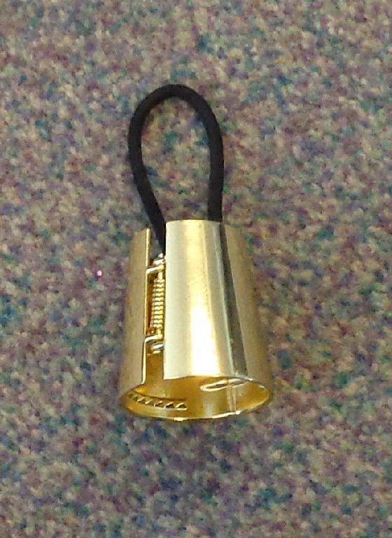 A PONYTAIL HEADBAND DESIGNED FOR WOMEN. THE PRODUCT IS A HOLLOW CIRCULAR GOLD COLOURED METAL TUBE, APPROXIMATELY 40MM IN LENGTH. IT HAS AN ELASTICATED HAIRBAND SECURED TO THE INSIDE OF THE TUBE. IT HAS A HINGE OPENING ON ONE SIDE. TO USE THE PRODUCT YOUR HAIR IS PUT IN A PONYTAIL AND SECURED BY THE BAND THEN THE METAL TUBE IS PLACED OVER THE BAND AND HAIR AT THE POINT NEAREST TO THE SCALP. THIS DESIRED EFECT IS THE PONYTAIL IS ELEVATED ABOUT 4CM AWAY FROM THE HEAD.