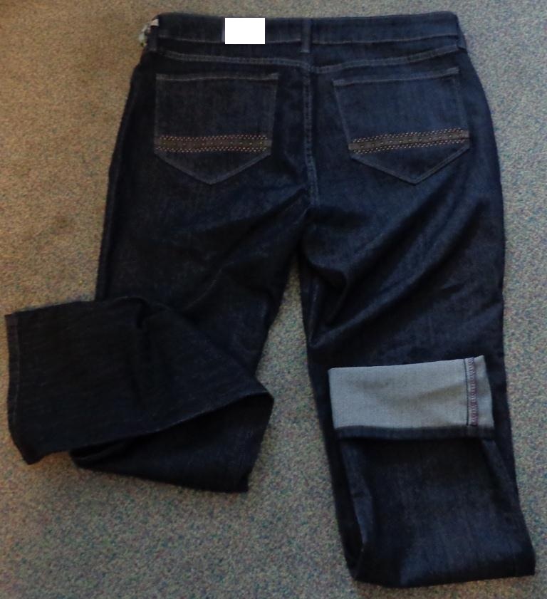 A PAIR OF WOVEN TROUSERS, MADE OF COTTON, POLYESTER AND ELASTAINE. 3-THREAD OR 4-THREAD TWILL COMPOSED OF  DYED WARP YARNS AND UNBLEACHED FILLING YARNS. THE FABRIC WEIGHS MORE THAN 200 GRAMS PER SQUARE METRE. FEATURING TWO POCKETS AT THE FRONT AND TWO POCKETS AT THE REAR WITH LEATHER  AND METAL STUD EMBELLISHMENTS. THE TROUSERS ARE LEFT OVER RIGHT FASTENING WITH A BUTTON AND ZIPPER. HEMMED.