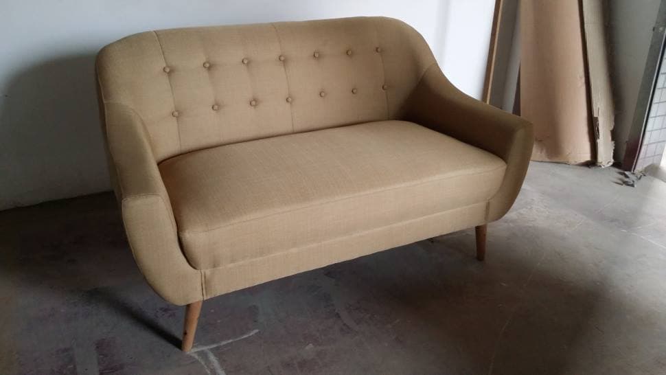 A 3 SEATER SOFA UPHOLSTERED IN A FABRIC MATERIAL WITH A FOAM INNER. THE FRAME OF THE SOFA IS MDF WITH LEGS OF SOLID WOOD. FOR USE WITHIN A LIVING ROOM. DIMENSIONS 148 x 85 x 86 CMS