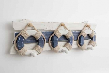 WOODEN KEY OR COAT RACK MADE FROM NON-TROPICAL WOOD WITH A NAUTICAL THEME. THE THREE HOOKS ARE MADE FROM SMALL SHAPED PIECES OF WOOD ATTACHED TO WOODEN LIFE BUOYS. DECORATED WITH ROPE.
