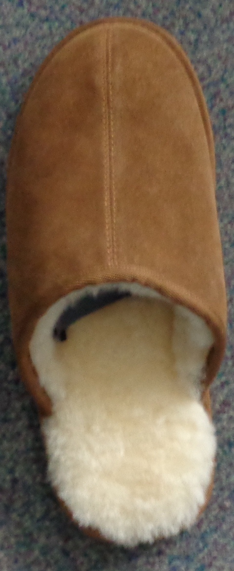 A MANS SHEARLING MULE SLIPPER WITH AN UPPER OF SUEDE LEATHER. THE SOLE IS A COMBINATION OF TEXTILE AND OTHER MATERIAL WITH THE TEXTILE BEING THE PREDOMINANT MATERIAL IN CONTACT WITH THE GROUND. TEXTILE SOLE DURABILITY TESTED UNDER THE MARTINDALE ABRASION TEST AND PASSED AT 51,200 REVOLUTIONS.