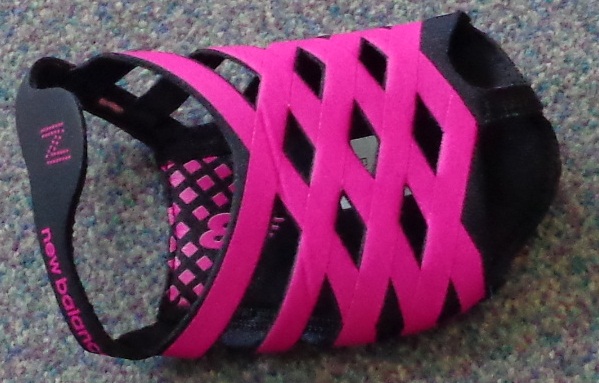 DANCE FOOTWEAR WITH UPPER AND SOLE OF TEXTILE. ONLY COVERING THE FRONT OF THE FOOT. WITH CUT OUT FOR THE TOES (THONG STYLE). WITH MESH PINK STRAPS ACROSS TOP. WORN FOR PROTECTION FOR THE BALL OF THE FOOT, SLIP ON INDOOR TRAINING SHOE PREDOMINATELY USED FOR THE LIKES OF YOGA.