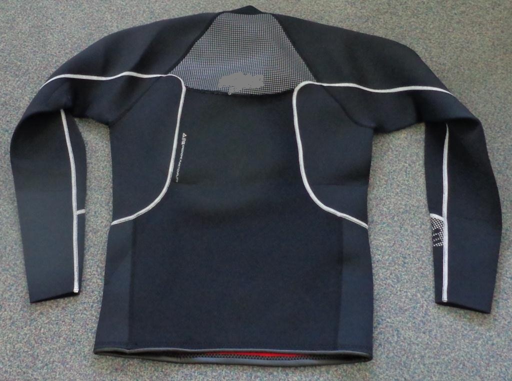 A KNITTED PULLOVER STYLE GARMENT FOR UNISEX. MADE OF CELLULAR NEOPRENE RUBBER COVERED ON BOTH SURFACES WITH A KNITTED NYLON TEXTILE. REACHING DOWN TO BELOW THE WAIST, ROUND NECK WITH A HIGH STANDING COLLAR WITHOUT OPENING, LONG SLEEVES, BOUND AT BASE OF GARMENT- 2.5 MM NEOPRENE, ZONED NEOPRENE TECHNOLOGY. WINDPROOF NEOPRENE PROTECTS THE TORSO, DOUBLE LINED NEOPRENE HELPS REDUCE WIND CHILL. FLAT LOCKED SEAMS FOR NEXT TO SKIN COMFORT. THE COLLAR IS MADE FROM NEOPRENE ONLY COVERED ON ONE SURFACE WITH TEXTILE. ARTICLE IS BLACK WITH SILVER TRIMS.