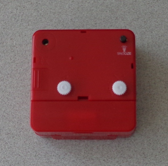 A BATTERY OPERATED ALARM CLOCK. WITH PVC DIAL, PLASTIC CASE AND PLASTIC KNOBS. THE DIMENSIONS OF THE CLOCK ARE 5.5 CM (H) X 5.5 CM (W) X 2.5 CM (D). THE PRODUCT IS PACKAGED IN A PVC RETAIL BOX WITH PAPER INSERT CARD