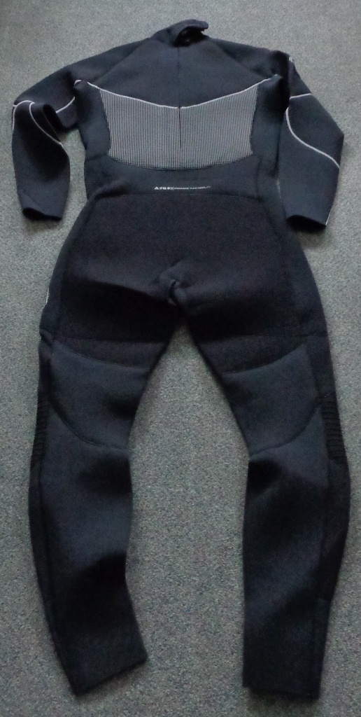 ARTICLE IS AN ALL IN ONE GARMENT WHICH COVERS THE ENTIRE BODY. COVERS THE LEGS DOWN TO THE ANKLES, TORSO, CHEST AND ARMS. THE ARTICLE IS MADE FROM A FABRIC WHICH IS OF A CELLULAR RUBBER COVERED ON BOTH SIDES WITH A KNITTED NYLON TEXTILE. ARTICLE IS BLACK AND DARK GREY IN COLOUR WITH SILVER CONTRAST STITCHING.THE GARMENT HAS A BACKZIP WITH NO LEFT OVER RIGHT OR RIGHT OVER LEFT COVERING FLAP. THE GARMENT IS CONSIDERED TO BE UNISEX. HAS ZONED NEOPRENE TECHNOLOGY WITH A HIGH LOFT NEOPRENE THAT PROTECTS THE TORSO. HAS X4 SUPERFLEX FABRIC ACROSS THE SHOULDERS, SIDES, UNDERARMS AND BEHIND THE KNEES. FOR COMPLETE FREEDOM OF MOVEMENT. LOW FRICTION AND A SOFT TOUCH GLIDESKIN COLLAR, ABRASION RESISTANT DI-GUARD SEAT AND KNEES. GLUED AND BINDSTITCHED CONSTRUCTION FOR A WATERPROOF SEAL. ALSO INCLUDES AN OVER THE HEAD GLIDESKIN NECK SEAL FOR REDUCED FLUSH AND IMPROVED HEAT RETENTION, LOW PROFILE WAIST AND LEG SEALS WITH SILICON GRIP PRINT. EMBOSSED KNEE PROTECTION.