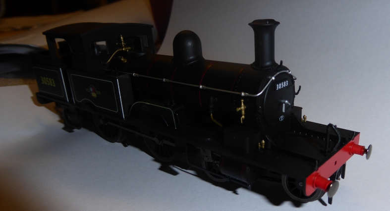 A MODEL OF A STEAM RAILWAY LOCOMOTIVE WITH A MOTOR. DESIGNED TO RUN ON 00 GAUGE TRACKS. IT HAS A SCALE OF 1:76. IT IS MADE OF PLASTIC, ZINC AND SMALL STEEL COMPONENTS. PREDOMINANTLY BLACK IN COLOUR. PACKAGED FOR RETAIL SALE.