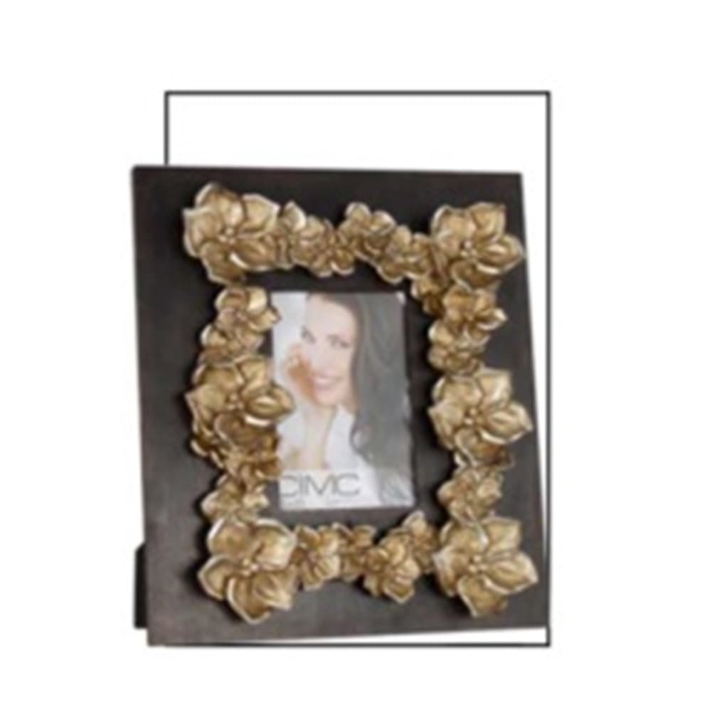 A PHOTO FRAME MADE OF WOOD (MDF) AND STAINED DARK BROWN, THE FRONT OF THE FRAME HAS A FLORAL DESIGN MADE OF ARTIFICIAL STONE (POLYRESIN) STUCK TO IT. THE DESIGN GOES AROUND THE GLASS WINDOW IN THE CENTRE OF THE FRAME. THE GLASS WINDOW HOLDS 6X4 INCH PICTURE. POLYRESIN IS MADE FROM 55% STONE AND 45% RESIN.