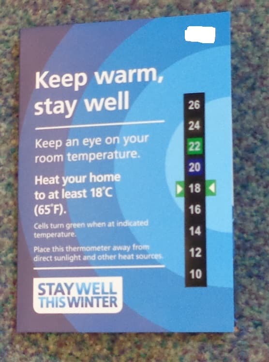 A CARD WITH THE TITLE KEEP WARM, STAY WELL. INCORPORATING A THERMOMETER WITH AN INDICATED TEMPERATURE SCALE RANGE FROM 10 DEGREES CENTIGRADE TO 26 DEGREES CENTIGRADE. THE THERMOMETER SHOULD BE PLACED AWAY FROM DIRECT SUNLIGHT AND OTHER HEAT SOURCES AND THE CELLS WITHIN THE THERMOMETER TURN GREEN WHEN AT INDICATED TEMPERATURE. THE CARD HAS PRINTED TEXT WITH INFORMATION FOR HEALTH SERVICE CUSTOMERS ON HOW TO PREVENT ILLNESS BY KEEPING WARM IN THE WINTER AND WITH ADVICE ON HOW TO KEEP WARM.