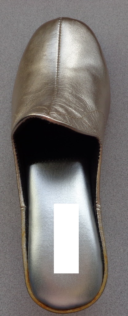 A LADIES MULE SLIPPER. NOT COVERING THE ANKLE. GOLD COLOURED UPPERS OF LEATHER. GREY COLOUR OUTER SOLE OF MANMADE PLASTIC MATERIAL. PADDED INTERIOR BEARING BRAND NAME. WEDGE TYPE HEEL. INSOLE LENGTH LESS THAN 24CM.