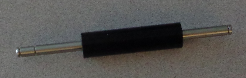 SILICONE RUBBER ROLLER ON A METAL SHAFT.THE PART IS FOR USE IN A MACHINE THAT PRINTS SECURITY ID CARDS. THEY ARE USED TO DRIVE THE CARD THROUGH THE PRINTING MACHINE. THE METAL SHAFT IS 12.5 CM IN LENGTH AND THE RUBBER ROLLER IS 5.7 CM IN LENGTH. EACH ROLLER IS BUILT SPECIFICALLY FOR THE PRINTING MACHINE.