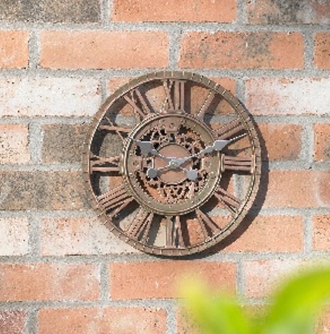 A WALL CLOCK MADE OF RESIN WITH A BRONZE EFFECT FINISH.  IT HAS A ROUND SHAPED FACE OF 12 INCH DIAMETER.  THE TIME IS INDICATED USING TWO SILVER COLOURED HANDS AND ROMAN NUMERALS.  THE CLOCK IS BATTERY OPERATED (REQUIRING 1 X AA BATTERY).  THE CLOCK IS PACKAGED IN A COLOUR PRINTED CARDBOARD BOX.
