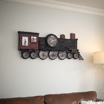 WALL MOUNTED CLOCK. MADE OF METAL (STEEL) IN THE FORM OF A STEAM TRAIN (FLAT) WITH PHOTOGRAPHY HOLDER PANELS. CONTAINS 1 CLOCK. BATTERY OPERATED REQUIRING 1XAABATTERY, NOT INCLUDED, PACKED IN A PRINTED FULL COLOUR CARDBOARD BOX.