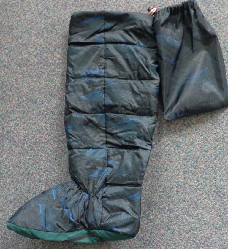 WELLINGTON BOOT SOCK

THE SOCK CONSISTS OF A  WOVEN TEXTILE  UPPER AND AN APPLIED WOVEN TEXTILE SOLE. THE SOLE IS STICHED TO THE UPPER. THE WHOLE PRODUCT IS DOWN FILLED THOUGHOUT.
THE APPLIED WOVEN TEXTILE SOLE HAS  RUBBER GRIPS. THE RUBBER GRIPS TAKE THE FORM OF ONE  RECTANGULAR PIECE OF RUBBER WHICH SURROUNDS  THE COMMERCIAL NAME OF THE SOCK WHICH IS ALSO IN  RUBBER.  IT IS THE WOVEN TEXTILE THAT FORMS THE MAJORITY OF THE SOLE.

AT THE TOP OF THE SOCK THERE IS A CORD  FASTENING.

ALSO COMES WITH AN APPROXIMATE  22 CMS BY 14CMS WOVEN TEXTILE BAG WITH CORD FASTENING FOR STORAGE OF THE SOCK. THE BAG IS  MADE OF THE SAME MATERIAL AS THE UPPER OF THE SOCK BUT WITHOUT ANY OF THE DOWN FILLING.

THE PRODUCT IS INTENDED TO BE WORN AS A LINER IN WELLINGTON BOOTS.