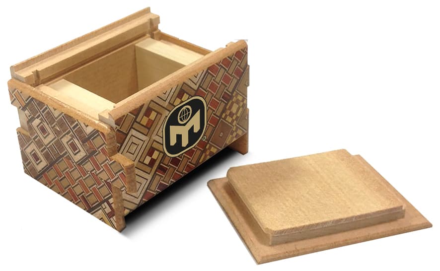 A JAPANESE PUZZLE BOX MADE OF WOOD. IT IS OPENED BY MEANS OF A SEQUENCE OF SLIDING MOVEMENTS. IN A DISPLAY BOX FOR RETAIL SALE.