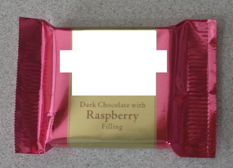 A 15.1G DARK CHOCOLATE SQUARE WITH A RASPBERRY FLAVOUR FILLING. INDIVIDUALLY WRAPPED IN A PRINTED PINK, BLUE AND GOLD COLOURED SEALED WRAPPER.