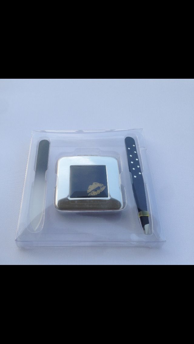 A TRAVEL SET CONSISTING OF TWEEZERS, A GLASS NAIL FILE AND A MIRROR. PACKAGED IN A CLEAR ACETATE BOX.