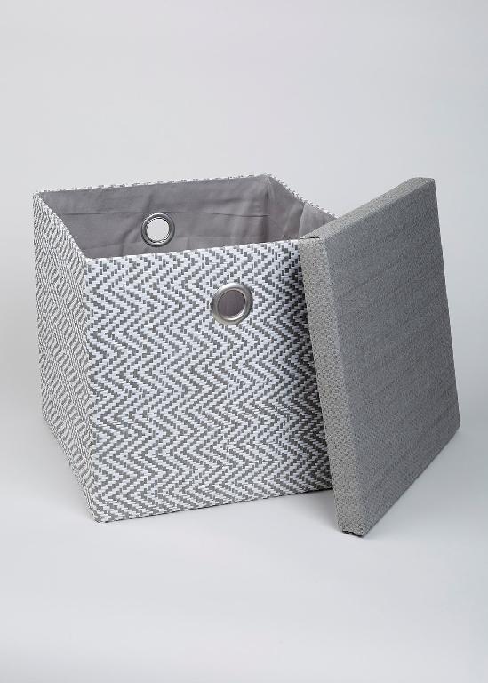 FOLDABLE FABRIC STORAGE BOX  FOR USE IN THE HOME. MADE FROM PAPERBOARD WITH PAPER OUTER AND 100% POLYESTER LINING. WITH CARRY HANDLES. WITH A DETACHABLE LID. MEASURES APPROXIMATELY 33  X  33  X  31 CMS. PUT UP FOR RETAIL SALE.