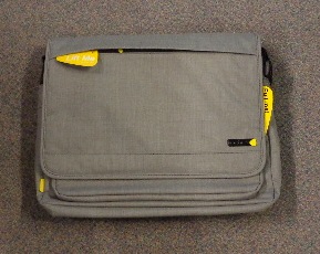 A 15.6 INCH GREY TEXTURED POL;YESTER MAGNETIC LAPTOP MESSENGER BAG. HAS 2 COMPARTMENTS, FEATURES  REMOVABLE MAGNETIC POCKETS, FAUX FUR LINING AND ADJUSTABLE SHOULDER STRAP. ZIP CLOSURE AT TOP..FOLD OVER FLAP AT FRONT ALSO CONSISTS OF A ZIPPED POCKET.