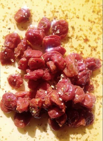 PEELED RED BABY PLUM TOMATOES, THIS PRODUCT IS READY TO EAT AS IT HAS BEEN COOKED AND MARINATED. INGREDIENTS INCLUDE, PEELED RED BABY PLUM TOMATOES, RAPESEED OIL, GARLIC AND OREGANO. PACKAGED IN FOOD GRADE POUCH/BAG.