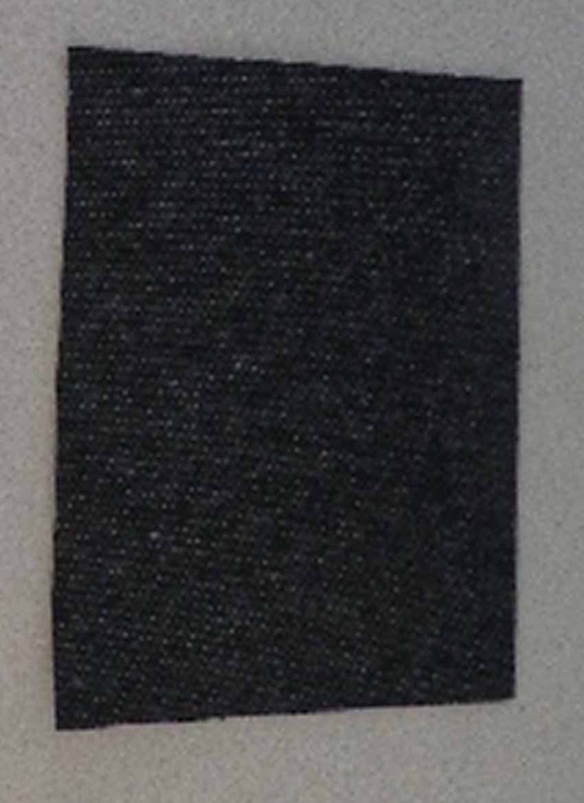 FABRIC CONSISTING  OF A  BLACK CENTRAL LAYER OF A RETICULATED POLYURETHANE FOAM THAT HAS BEEN COATED THROUGHOUT WITH ACTIVATED CARBON.

 LAMINATED ON ONE SIDE OF THIS IS A GREY/BLACK  KNITTED POLYCOTTON TEXTILE  CREATED BY A COMBINATION OF DIFFERENT COLOUR YARNS USED IN THE FABRIC.  

LAMINATED ON THE OTHER SIDE OF THE POLYURETHANE IS A COLOURLESS/LIGHT GREY NON-WOVEN TEXTLE. 

THE ADHESIVE USED IN THE LAMINATION IS BASED ON EVA,

THE TOTAL CONSTRUCT OF THE FABRIC HAS A NOMINAL WEIGHT OF 300-400 GSM AND IS SUPPLIED ON A ROLL OF A NOMINAL WIDTH OF 1.5 METRES. 

THE CELLULAR PLASTIC MIDDLE LAYER IS VISIBLE TO THE NAKED EYE AND THE TEXTILE CONSIDERED LAYERS ARE  CONSIDERED TO BE MORE THAN FOR  REINFORCEMENT.

THE FABRIC IS USED IN THE MANUFACTURE OF UNIFORMS, WARFARE WEAR AND PROTECTIVE EQUIPMENT WITH THE INTENDED FUNCTION OF OFFERING CHEMICAL PROTECTION.