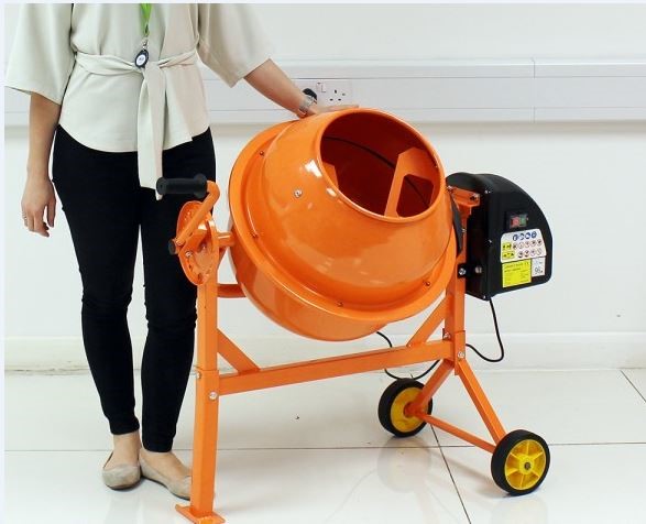 A CONCRETE CEMENT MIXER MADE OF STEEL WITH WHEELS AND A STAND, SPRAY PAINTED ORANGE. DRUM CAPACITY 63L, MOTOR 220W. DRUM DIAMETER 420MM. DIMENSIONS: 1070MM X 510MM X 885MM. WHEEL BARROW TYPE MULTIMIXER. BOXED WITH EASY ASSEMBLY AND READY TO GO IN 15 MINUTES AND CAN BE DISASSEMBLED IN 1 MINUTE FOR TRANSPORT.