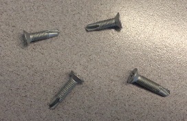 FLAT HEAD, METRIC THREAD, DRILL POINT SCREWS MANUFACTURED FROM MARTENSITIC STAINLESS STEEL WITH A TWO STAGE CHROMIUM FREE INORGANIC ANTI-CORROSION COATING. USED IN THE MECHANICAL JOINTING OF ITEMS TO METAL, COMPOSITE MATERIALS AND PVCU.