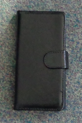 A LEATHER CASE FOR A MOBILE PHONE, IN THE FORM OF A WALLET. IT HAS A HINGED SIDE FLAP, WITH A MAGNETIC CLASP ON THE OTHER SIDE TO CLOSE IT. THIS SIDE HAS A RAISED EDGE.WHICH COVERS THE SIDE. INTERNALLY THERE ARE POCKETS FOR THREE CARDS. NO STRAP OR HOOK AS IT INTENDED TO BE CARRIED IN A POCKET OR HANDBAG. PUT UP FOR RETAIL SALE IN A POLYPROPYLENE RESEALABLE POUCH
