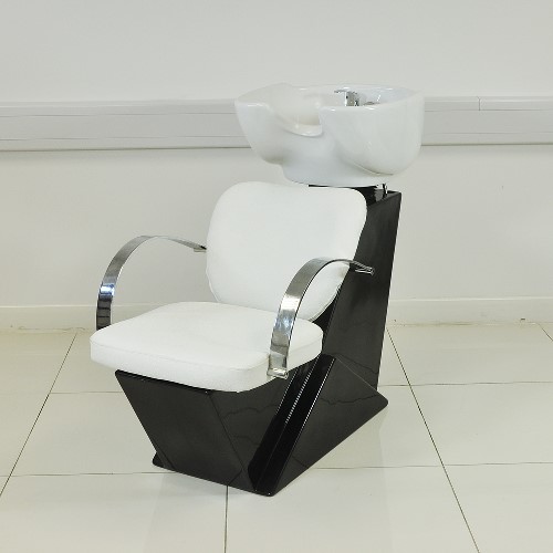 A SALON WASH UNIT. THE PRODUCT COMPRISES OF A CHAIR AND A WASH BASIN.
THE CHAIR IS CONSTRUCTED FROM A STURDY FIBRE GLASS FRAME WITH A HIGH GLOSS BLACK FINISH WITH A TEXTURED LEATHER EFFECT UPHOLSTERED SEAT AND CHROME EFFECT METAL ARMS WITH CREAM PADDED ARM RESTS. IT HAS A LARGE WHITE CERAMIC SINK ATTACHED TO THE BACK OF THE CHAIR. THE SINK INCLUDES A CHROME EFFECT , MONOBLOC SINGLE MIXER TAP WHICH PROVIDES THE IDEAL TEMPERATURE WATER TO THE INTEGRAL SHOWER HOSE WHICH HAS A 50MM DIAMETER HEAD. THE SINK BOWL HAS AN ADJUSTABLE TILT AND IS COMPLETE WITH SINK PLUG AND REMOVABLE WASTE BASKET. THE UNIT INCLUDES HOT AND COLD CLEAN WATER AND WASTE WATER HOSE FITTINGS. THE CHAIR CAN BE USED WITH OR WITHOUT THE WASH FACILITY.