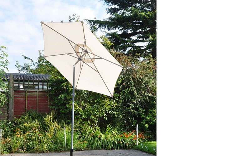 A TWO METRE LIGHTWEIGHT CREAM OUTDOOR PARASOL. CONTAINED IN A BOX AND PUT UP FOR RETAIL SALE.