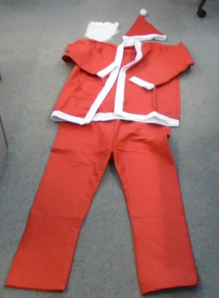 5 PIECE SANTA SUIT FOR ADULTS .  GARMENTS ARE MADE OF NON-WOVEN FELT MATERIAL.  THE YARN OF THE FELT IS 100% POLYESTER.   FOR UNISEX.  THE SET INCLUDES RED JACKET WHICH IS TRIMMED WITH WHITE ROUND THE WHOLE JACKET AND AT THE SLEEVE CUFFS (THE WHITE IS CONSIDERED TO BE MERE TRIM).  THE JACKET HAS NO FASTENING AT THE FRONT AND THEREFORE CAN CROSS OVER RIGHT TO LEFT OR LEFT TO RIGHT.  RED TROUSERS WITH A DRAW STRING TIE AT THE WAIST.   BLACK PLASTIC WAIST BELT WITH PLASTIC BUCKLE.  RED TRIANGLE SHAPED HAT THE BRIM IS TRIMMED IN WHITE WITH A WHITE POM-POM ON TIP.  WHITE FALSE BEARD AND MOUSTACHE WITH ELASTIC STRAP TO HOLD IN PLACE AT BACK OF HEAD.   

JACKET MEASURES APPROXIMATELY 57 CMS ACROSS THE CHEST X 67 CMS IN LENGTH.  WAIST OF TROUSER MEASURES APPROXIMATELY 55 CMS X LENGTH OF 110 CMS FROM WAIST TO TOE.

ALL 5 ITEMS TROUSERS, JACKET, BEARD, BELT AND BEARD ARE PACKAGED IN ONE PLASTIC BAG WITH SMALL FLYER SHOWING PICTURE OF SANTA SUIT AND COMPANY NAME AND LOGO.