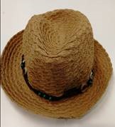 STRAW HAT WITH BRIM.  MADE OF 100% STRAW.  THE STRAW STRIPS ARE 1.5 CM WIDE AND PRE-MADE INTO PLAITING STRIPS .  THE PLAITING STRIPS ARE THEN SEWN IN TO A SPIRAL CONSTRUCTION TO FORM THE  HAT.   THE HAT HAS DECORATIVE TRIM AROUND THE JOIN OF THE HAT AND BRIM.