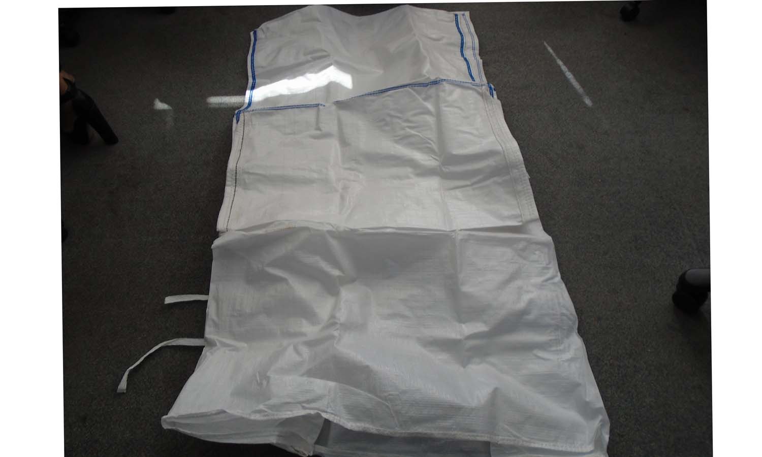 A FLEXIBLE INTERMEDIATE BULK CONTAINER IN THE FORM OF A LARGE POLYPROPYLENE SACK. THE CONSTRUCTION OF SACK IS MADE OF WOVEN POLYPROPYLENE STRIPS WITH A WIDTH OF LESS THAN 5MM. TO CONTAIN POWDERS AND GRANULAR PRODUCTS OF VARYING AMOUNTS DEPENDANT ON BULK DENSITY.