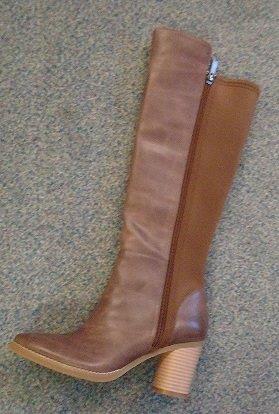 LADIES KNEE HIGH BOOTS WITH ZIP FASTENING.  UPPERS OF LEATHER AND TEXTILE MATERIAL.  VAMP, HEEL SECTION AND FRONT HALF OF BOOT IS LEATHER WITH TEXTILE MATERIAL STRETCH BACK SECTION.  LEATHER IS THE PREDOMINANT MATERIAL OF THE UPPER.  THE LEATHER AND TEXTILE MATERIAL ARE CINNAMON IN COLOUR.  THE BOOTS COVER THE ANKLE AND THE CALF.  FRONT SECTION OF BOOT IS 3 CM HIGHER THAN THE BACK PART.  FRONT SECTION HAS 4 CMS SPLIT BELOW THE KNEE.  OUTER SOLES OF RUBBER.  HEEL HEIGHT 7 CMS.  FULL LENGTH ZIP.  LINING OF OTHER MATERIALS (TEXTILE).  REMOVABLE INNER SOLE WITH ARCH SUPPORT.  INSOLES OF A LENGTH MORE THAN 24 CMS.