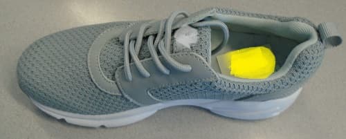 LADIES LACE UP SHOE FOR SPORTS WEAR.  UPPER OF TEXTILE MATERIAL AND LEATHER.  THE TEXTILE MATERIAL IS THE PREDOMINATE MATERIAL OF THE UPPER.  SHOE IS GREY IN COLOUR. TEXTILE DIAMOND PATTERNED HEEL COUNTER WITH LEATHER REINFORCEMENT AND TEXTILE HEEL LOOP.  FOUR HOLE LEATHER EYESTAY.  EMBROIDERED LOGO ON SIDE OF UPPER.  OUTER SOLE OF RUBBER.  REMOVABLE INSOLE WITH CUSHIONING GEL HEEL INSERT.  LIGHT WEIGHT SHOE.  SHOE IS SUITABLE FOR WEARING TO THE GYM AND LIGHT EXERCISE.  NOT COVERING THE ANKLE.  INSOLES OF A LENGTH 24 CMS OR MORE.