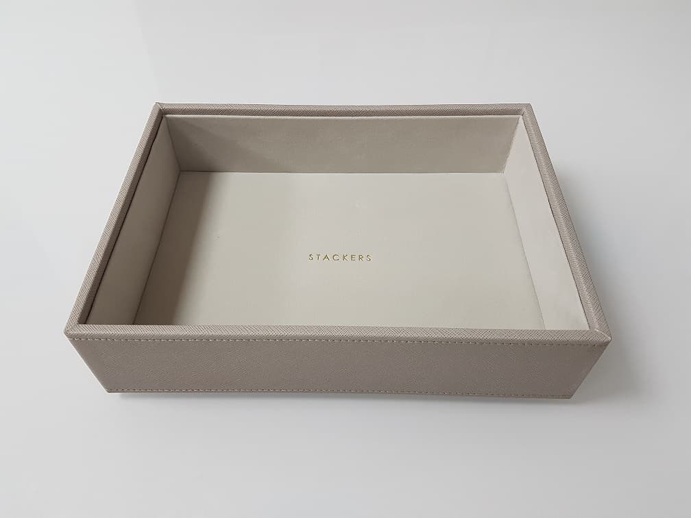 JEWELLERY DISPLAY BOX DEEP LAYER. MADE FROM MEDIUM DENSITY FIBREBOARD (MDF) CONSTRUCTION (60%), POLYESTER LINING (18%), WITH A POLYURETHANE OUTER SURFACE (18%) AND SPONGE (4%). INDIVIDUAL COMPARTMENT SHAPED TO HOLD AND DISPLAY JEWELLERY. THE ESSENTIAL CHARACTER OF THE BOX IS IMPARTED BY THE MDF FRAME, WHICH PREDOMINATES IN WEIGHT, VALUE, AND WHICH GIVES THE BOX ITS STRUCTURE AND FUNCTION. INCLUDES COMPANY LOGO ON THE INSIDE OF BOX.