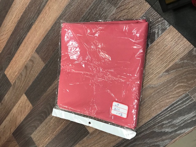 A TABLE CLOTH. MADE OF WOVEN POLYESTER. PACKED IN A PLASTIC BAG
