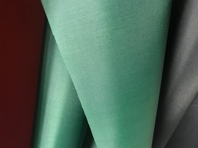 WOVEN POLYESTER TEXTILE FABRIC. SAID TO HAVE A NON CELLULAR PU COATING, WHICH IS NOT CONSIDERED TO BE VISIBLE TO THE NAKED EYE. ON A ROLL. SAMPLE SEEN ORANGE IN COLOUR