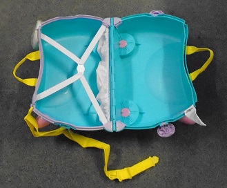 AN ARTICLE OF MOULDED PLASTIC MEASURING APPROXIMATELY 48 X 29 X 20 CM FEATURING;  FOUR WHEELS, TWO TEXTILE CARRYING HANDLES, TWO PROTURDING HORNS, DETACHABLE TEXTILE SHOULDER STRAP INCORPORATING THE KEY FOR THE TWO SIDE LOCKS.  DETACHABLE HAIR LIKE TAIL, FABRIC UNICORN HORN STICKER, AND ADDITIONAL EXTERIOR FOAM SHAPED STICKERS.  IT OPENS IN TWO HALVES ARTICULATED BY HINGES. INSIDE ONE HALF INCORPORATES TWO ELASTIC TYPE STRIPS FORMING A CROSS SECURED BY A PLASTIC CATCH, AND A NARROW FABRIC POCKET AT BASE OF THE ARTICLE.

THE ARTICLE IS DESIGNED THAT WHEN IT IS CLOSED A CHILD IS ABLE TO SIT AND RIDE OR BE PULLED ALONG ON.