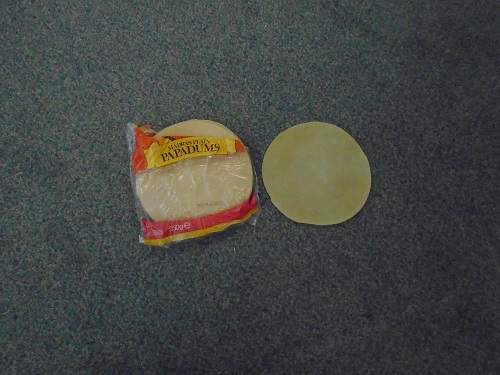 PACK OF MADRAS PLAIN POPPADUMS.  TO BE FRIED IN HOT OIL BEFORE CONSUMPTION.  250 GRAM PACK CONTAINING NUMEROUS INDIVIDUAL POPPADUMS.  INGREDIENTS INCLUDE: URAD FLOUR (VIGNA MUNGO), RICE FLOUR, SALT, CALCIUM CARBONATE AND COCONUT OIL.  PACKAGED IN PLASTIC WRAPPER READY FOR RETAIL SALE.  NUTRITIONAL INFORMATION, COOKING AND STORAGE INSTRUCTION PRINTED ON BACK OF WRAPPER.