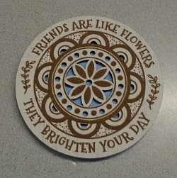 COASTER MADE FROM MDF. THE COASTER IS 5MM THICK WITH 2 LAYERS. THE BOTTOM LAYER IS BLUE IN COLOUR WITH A PRINTED FLORAL DESIGN ON THE TOP LAYER. TOP LAYER IS WHITE IN COLOUR WITH THE PRINT AND FLORAL DESIGN BEING BROWN.