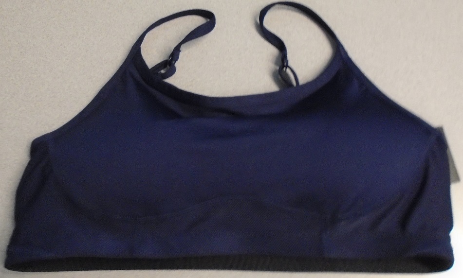 A WOMENS KNITTED POLYESTER BRA TOP, REACHING DOWN TO BELOW THE BUST. WITHOUT OPENING. WITHOUT FASTENING. WITH ADJUSTABLE SHOULDER STRAPS. NAVY BLUE IN COLOUR. HI IMPACT FOR SPORTS. WITH REFLECTIVE COMPANY LOGO IN THE MIDDLE OF THE BACK.