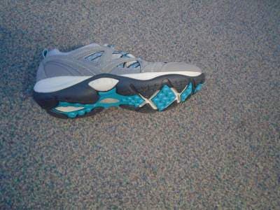 LADIES GREY TRAINER WITH TEXTILE AND PLASTIC UPPERS, WHERE THE TEXTILE PREDOMINATES. TRAINER HAS GREY SUEDE REINFORCEMENTS.LACE UPS AND REMOVEABLE INSOLE AND RUBBER OUTER SOLE.HEEL LOOP .2.5CM WEDGE HEEL.