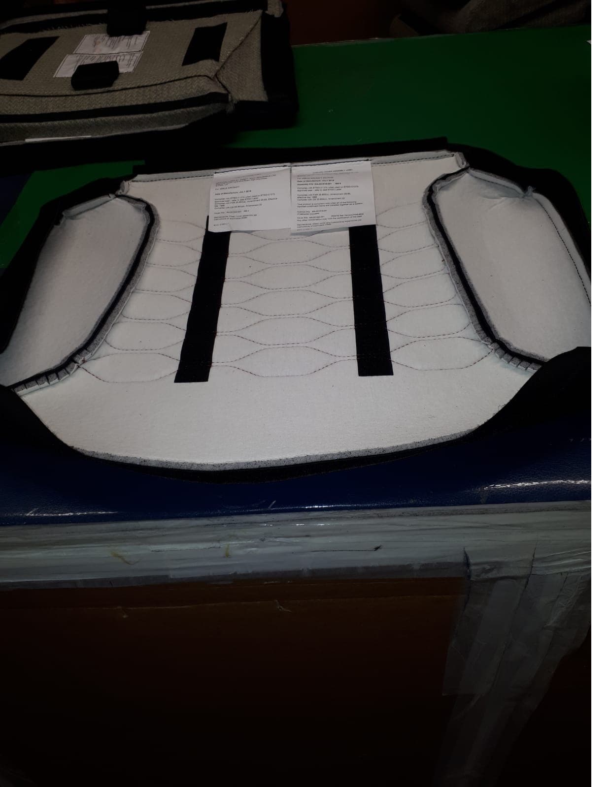 LEATHER AIRCRAFT SEAT COVERS.THE COVERS ARE 100% LEATHER WITH SOME PADDING .THERE ARE METAL RIVETS ATTACHED TO A VELCRO STRIP AT THE BOTTOM OF THE COVER.THESE ARE USED FOR FASTENING THE COVER.THE COVERS ARE FULLY REMOVABLE WITHOUT HAVING TO DISMANTLE THE SEAT.