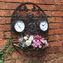 WALL MOUNTED GARDEN CLOCK WITH THERMOMETER WHICH ALSO FEATURES A PLANTER WITH A BASKET AND LINER.
HAS AN IRON SURROUND, PAINTED BLACK. 
THE CLOCK FACE MEASURES 12CM IN DIAMETER, WITH ROMAN NUMERALS.
BATTERY OPERATED. REQUIRES 1 X AA BATTERY WHICH IS NOT INCLUDED.
PACKAGED FOR RETAIL SALE IN A PRINTED COLOURED CARDBOARD BOX.